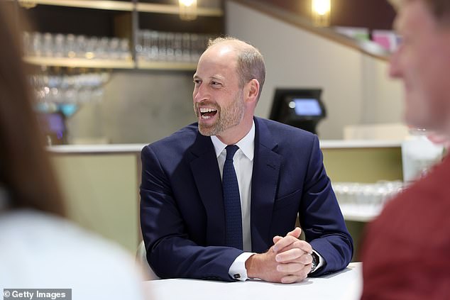 Prince William talks to teammates from Jac Lewis's team Ammanford FC in Cardiff today