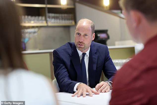 Prince William talks to teammates from Jac Lewis's team Ammanford FC in Cardiff today