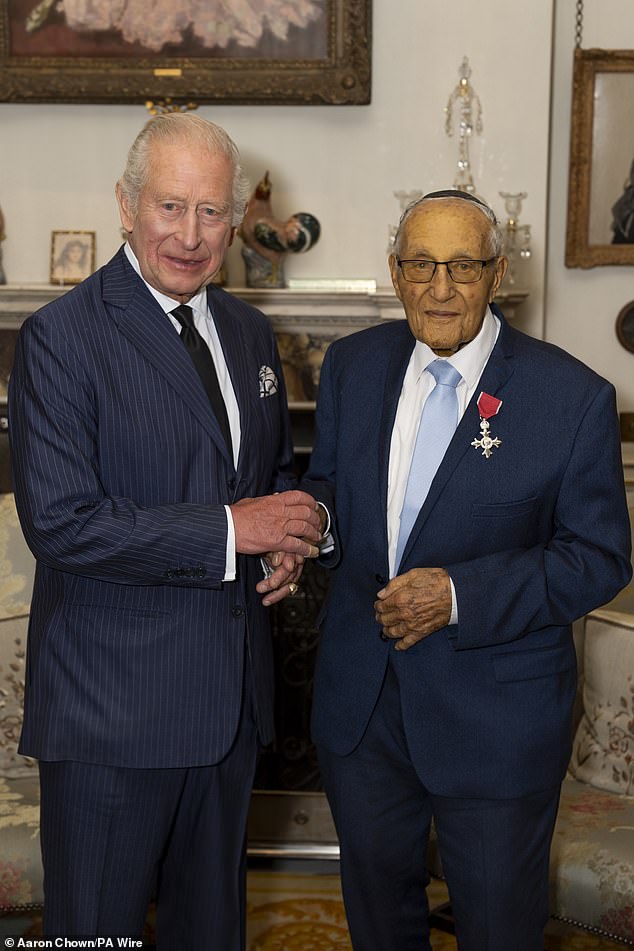 The King had entered Clarence House earlier today where he met with Holocaust survivor Manfred Goldberg (right) to invest him with an MBE