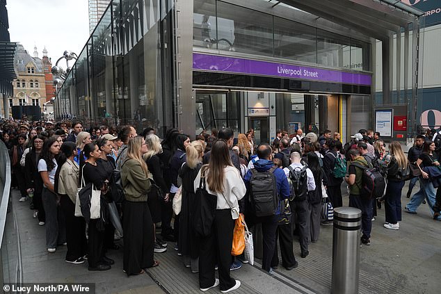 Passengers wait to enter London Liverpool Street station for Elizabeth line services yesterday