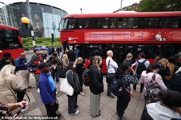 People queue for buses in Central London yesterday as the Tube strike causes travel misery