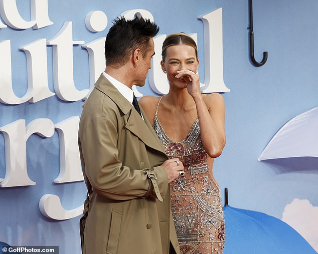 The actress was in high spirits as she giggled at her co-star while attending the premiere