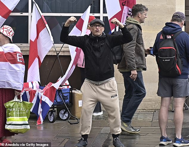 A man poses for pictures on Saturday morning as he joins supporters of Tommy Robinson for the Unite The Kingdom rally in London