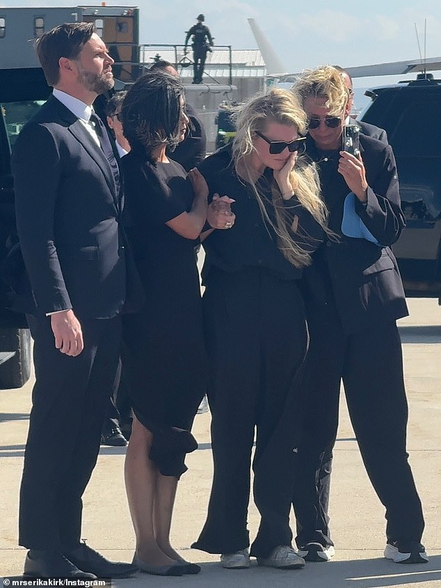 Erika also posted a series of photos of her on the tarmac to welcome her husband's body back to Arizona standing alongside JD Vance and his wife Usha, both seen left