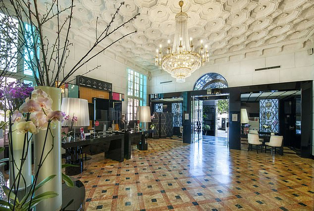 The bright, sparkling lobby of the hotel, with a grand chandelier and art deco features, is a stunning first impression of the building
