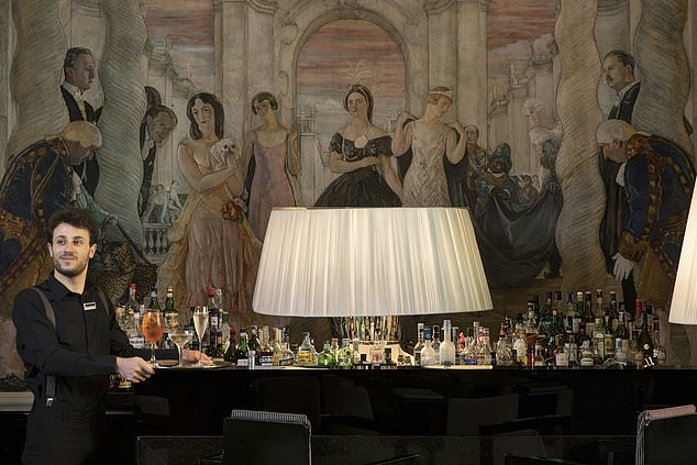 The bar is kitted out with more liqours than one can count, placed under one of Cadorin's paintings