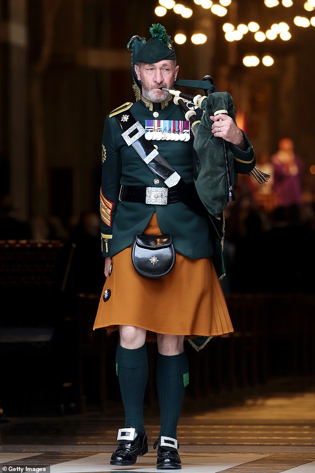 A piper from The Royal Dragoon Guards plays at Westminster Cathedral this afternoon