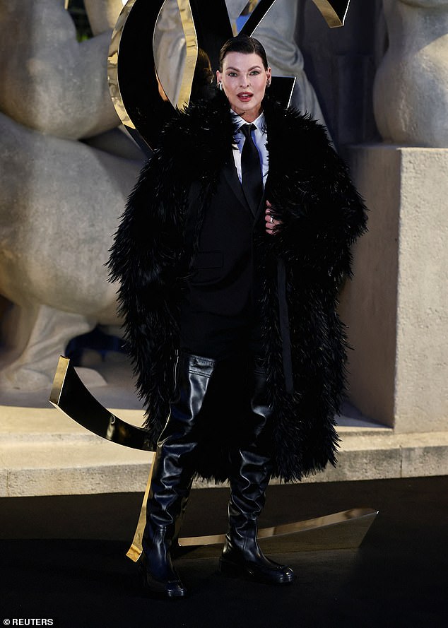Linda Evangelista let her dramatic black faux fur coat do the talking as she made a rare public appearance at the show