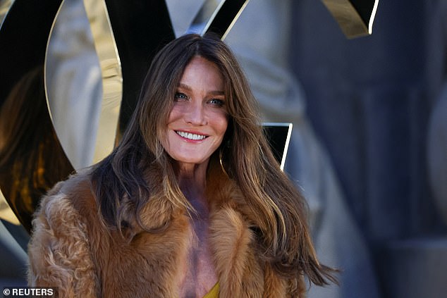 The Italian model, who is said to be standing by her husband during his time in jail, opted for a mustard yellow midi dress and a brown faux fur coat