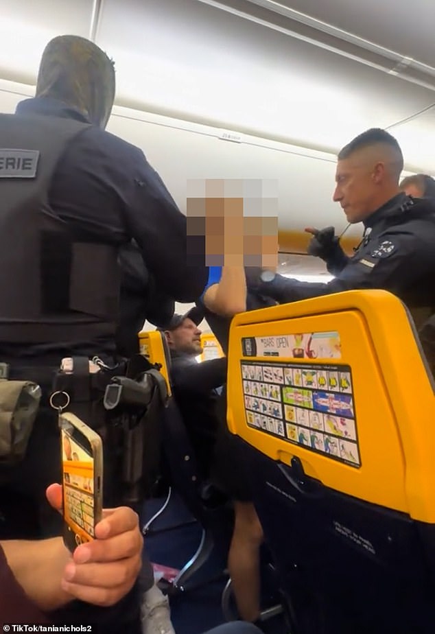 Shouting into Tania Nicohol's camera, the son directs her to stop filming, before warning an officer: 'You're making a mistake if you're coming for me'