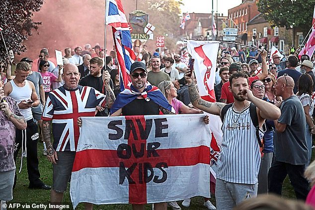 Anti-migrant protesters have erupted across the country amid concerns about asylum hotels (pictured are demonstrators outside Epping's Bell Hotel in Essex)