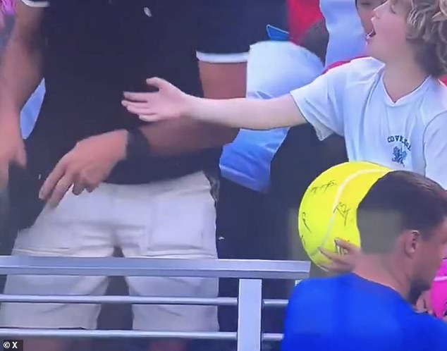 The disappointed young boy was seen asking 'What are you doing?' after the cap was taken