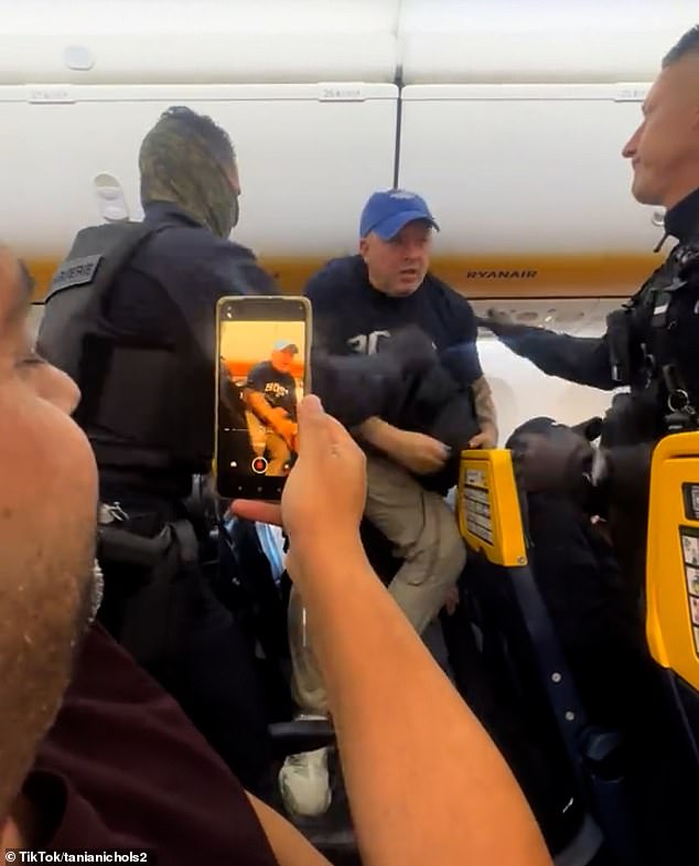 British father Ashley-Laws was dragged off the flight by elite special forces police last Friday