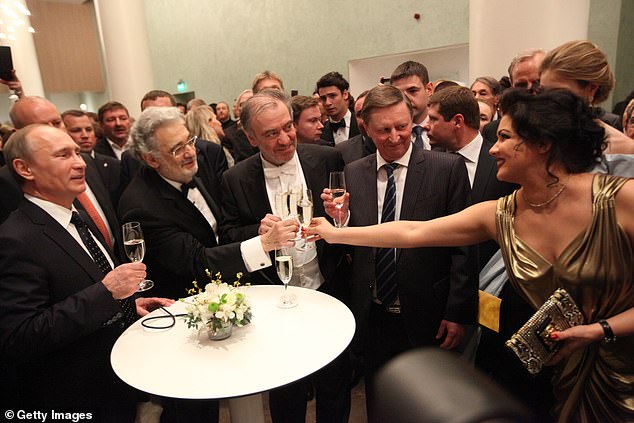 Russian President Vladimir Putin enjoys a drink with Anna Netrebko at the opening of a new theatre in St. Petersburg in 2013