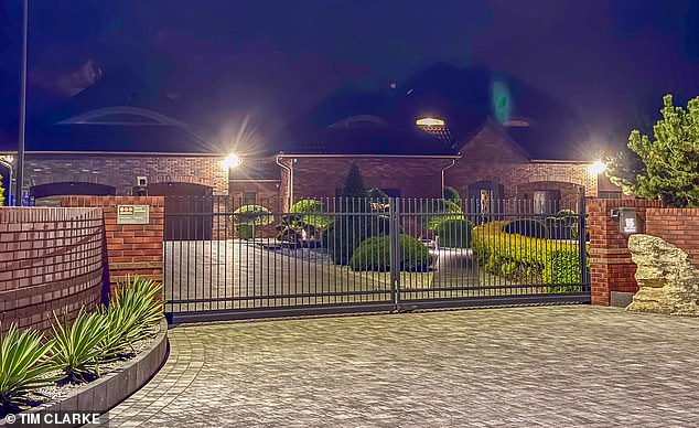 Mr Szczerek and his wife Anna live in the luxurious modern villa - complete with a tennis court in the back garden - in a small upmarket enclave known by locals as a 'village of millionaires'