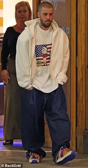 Justin additionally slipped into a pair of baggy denim jeans as well as comfy, colorful sneakers