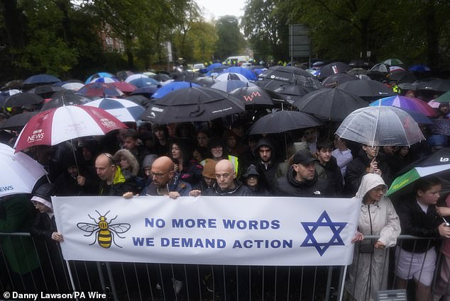 People attend a vigil on Middleton Road in Crumpsall, Manchester, after two people died in a terror attack at the Hebrew Congregation synagogue