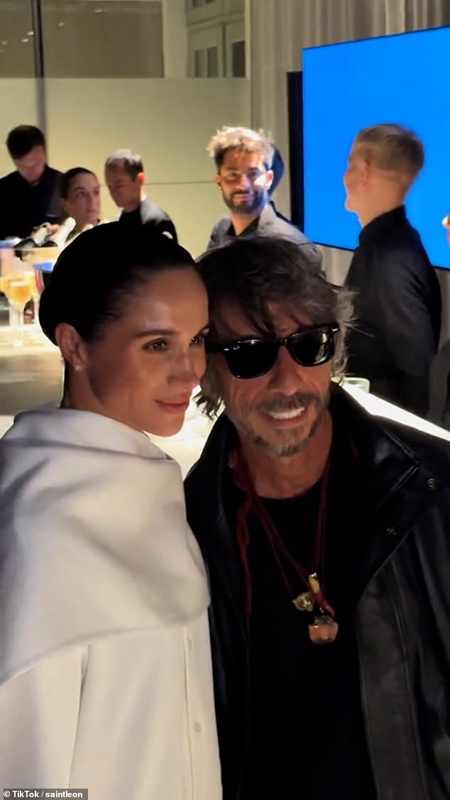 Laughing off the interaction, the pair pose for photos before sharing a brief hug