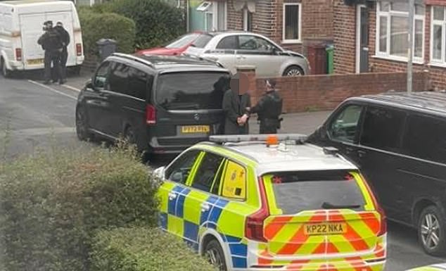 Following the incident, armed officers later reportedly arrested two men in a street just feet away from the deadly knife attack in Manchester (pictured: a man being detained by police)