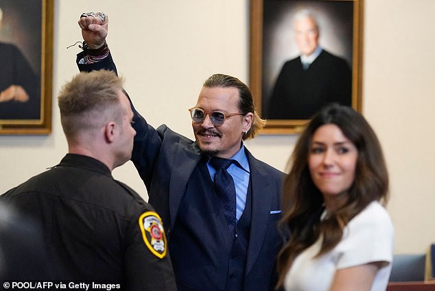 Johnny famously lost the libel action which he brought at the UK High Court in 2020, after being called a 'wife beater', but successfully brought a libel action against Heard in a US court in 2022  (Depp gestures to spectators in court after closing arguments at the Depp vs Heard trial)
