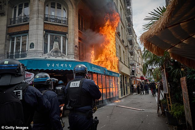 French Riot Police stand back as Wafu Brasserie burns after catching fire during violent clashes near Chatelet in central Paris on September 10, 2025