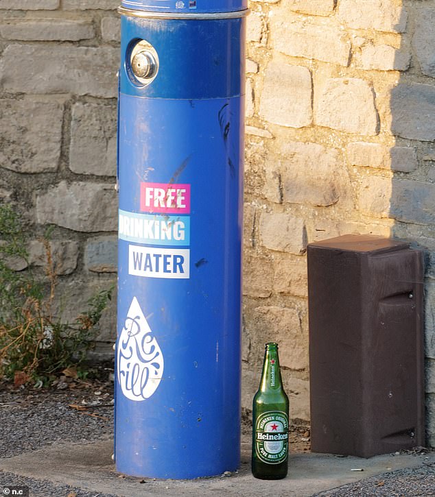 A lone Heineken bottle stands next to a water fountain. Locals have complained of litter across the town