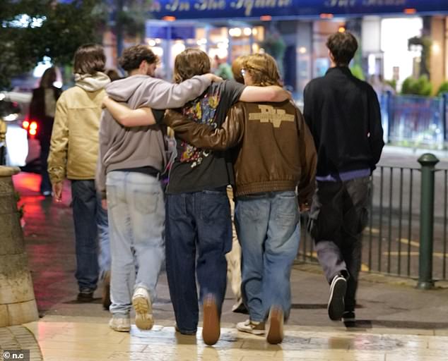 A group of friends, believed to be students, stagger through Bournemouth on a Wednesday night
