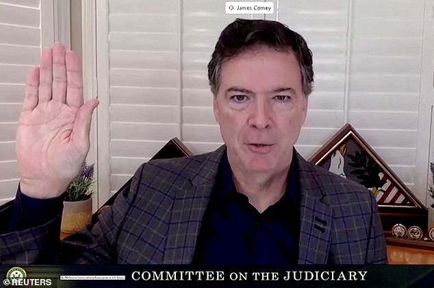 FILE PHOTO: James Comey, former director of the Federal Bureau of Investigation (FBI), is seen in a frame grab from a video feed as he is sworn in remotely from his home during a Senate Judiciary Committee hearing exploring the FBI's investigation of the 2016 Trump campaign and Russian election interference in Washington, U.S., September 30, 2020. U.S. Senate Committee on the Judiciary/Handout via REUTERS/File Photo