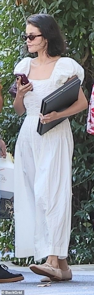 She paired her cottagecore style dress with a pair of cream flats