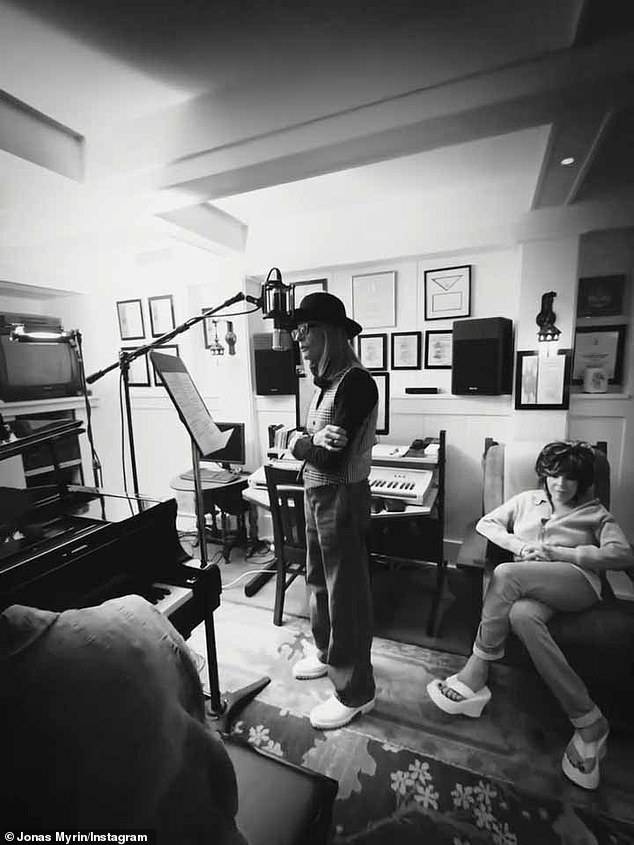 In poignant black-and-white footage from the recording studio, the Hollywood star could be seen standing beside a piano as she recorded her first-ever solo single