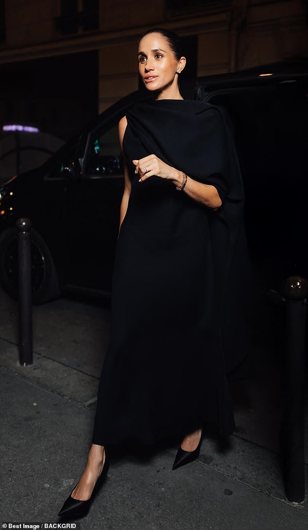 Meghan later looked elegant in all black in another Balenciaga outfit in Paris on October 4