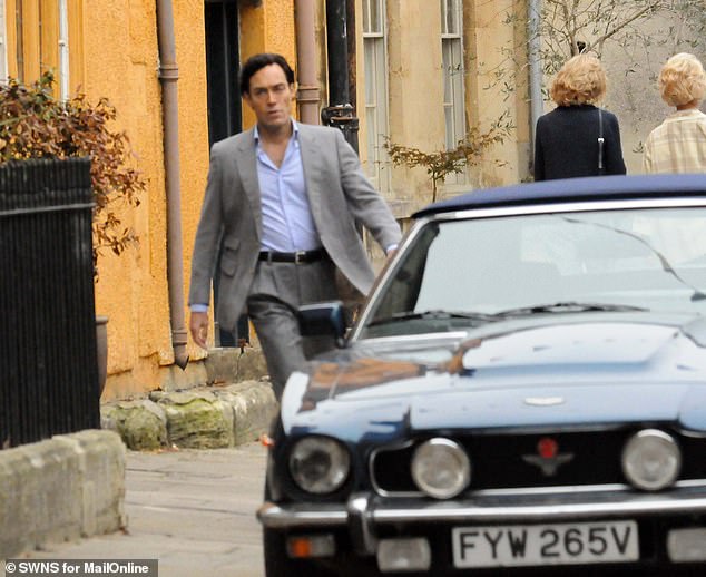 The cast shot scenes along the high street with eighties cars parked up along the road