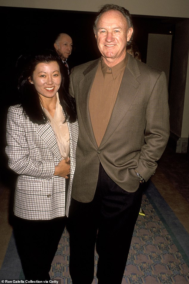 Hackman's wife of 33 years, Betsy Arakawa, died at home days before Hackman from the hantavirus. They were buried side-by-side in an unmarked plot earlier this year; seen in 1991