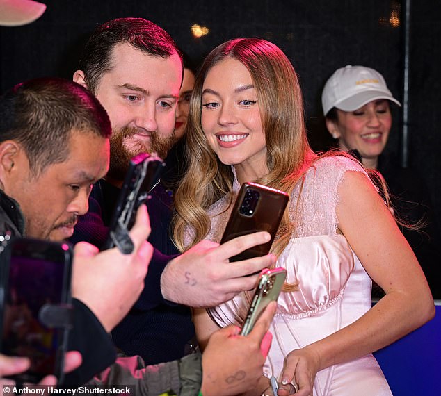 During Friday night's premiere, The White Lotus star happily took selfies with fans, blew kisses and posed with her younger brother