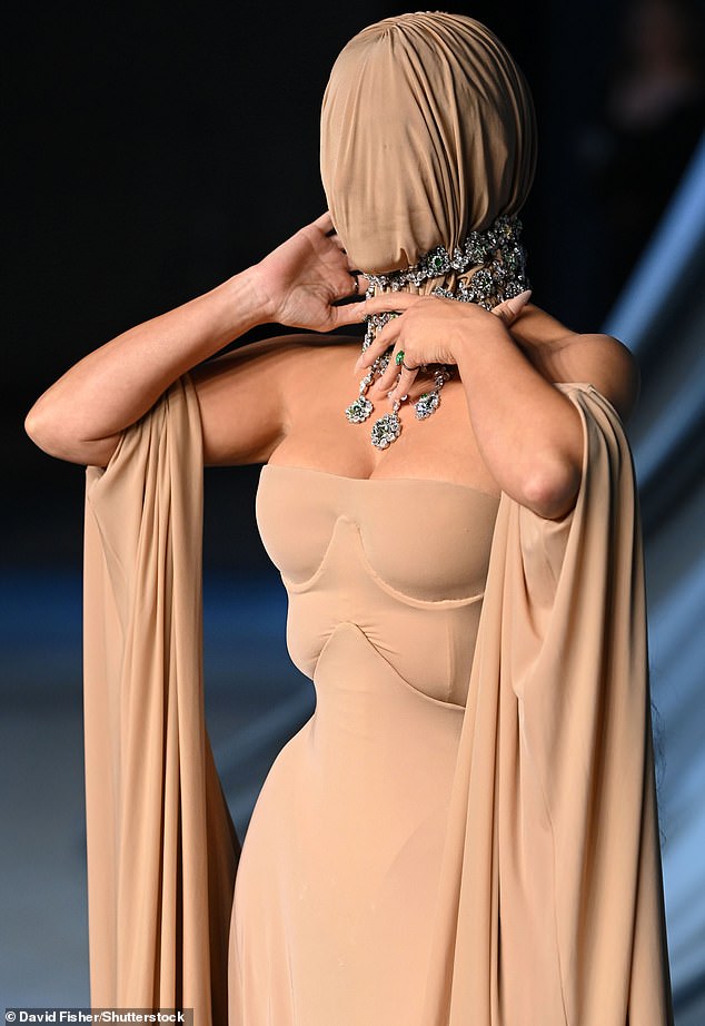 Matching material completely covered the reality star's head while an eye-catching diamond choker necklace was added on top