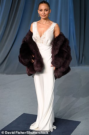 Nicole Richie exuded old Hollywood glamour wearing a sleeveless, white satin gown with lace details around the neckline