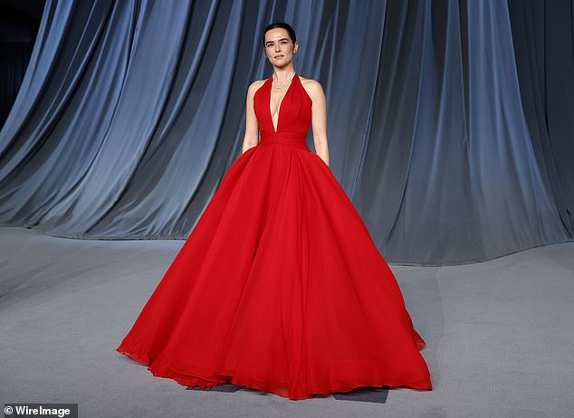 Zoey Deutch was breathtaking in a vibrant red ballgown with a plunging neckline on the front and full skirt