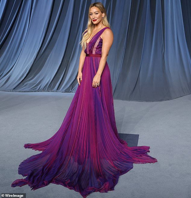 Hilary Duff was radiant in a colorful gown that had a flowy pleated skirt and plunging neckline on the front