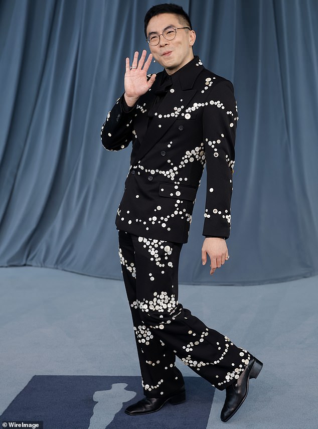 SNL star Bowen Yang opted for a black suit that had shimmering silver accents for a unique flare