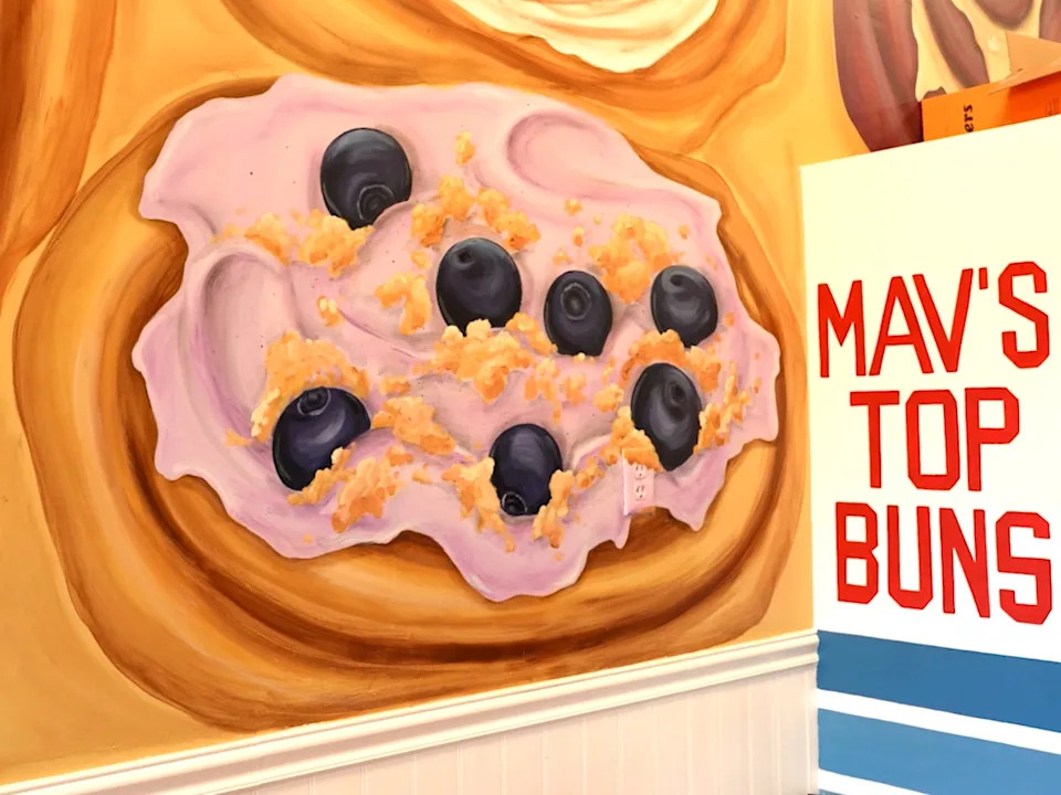 Sign that reads "Mav's Top Buns" inside bakery