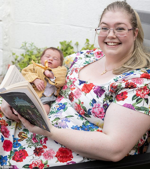 Ellis pictured with one of her hyper-realistic newborns; she says she worries that the fake baby scandal this week, in which Scottish woman Kira Cousins, 23, is alleged to have used a reborn to pretend she'd given birth, will see collectors of the hyper realistic dolls branded 'crazy'