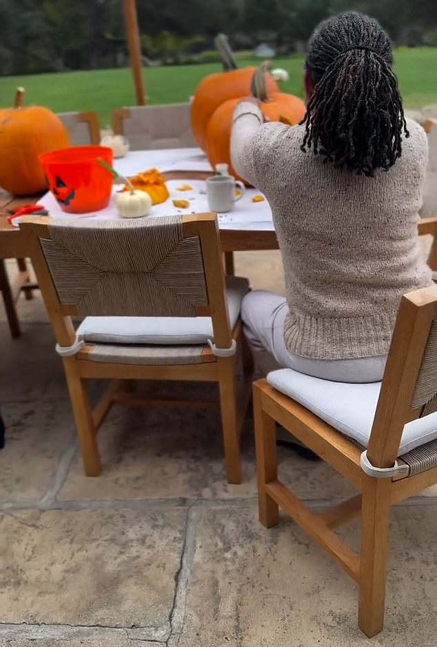 The back of a woman - who appears to be Meghan's mother - is also visible at one point, sitting at a table
