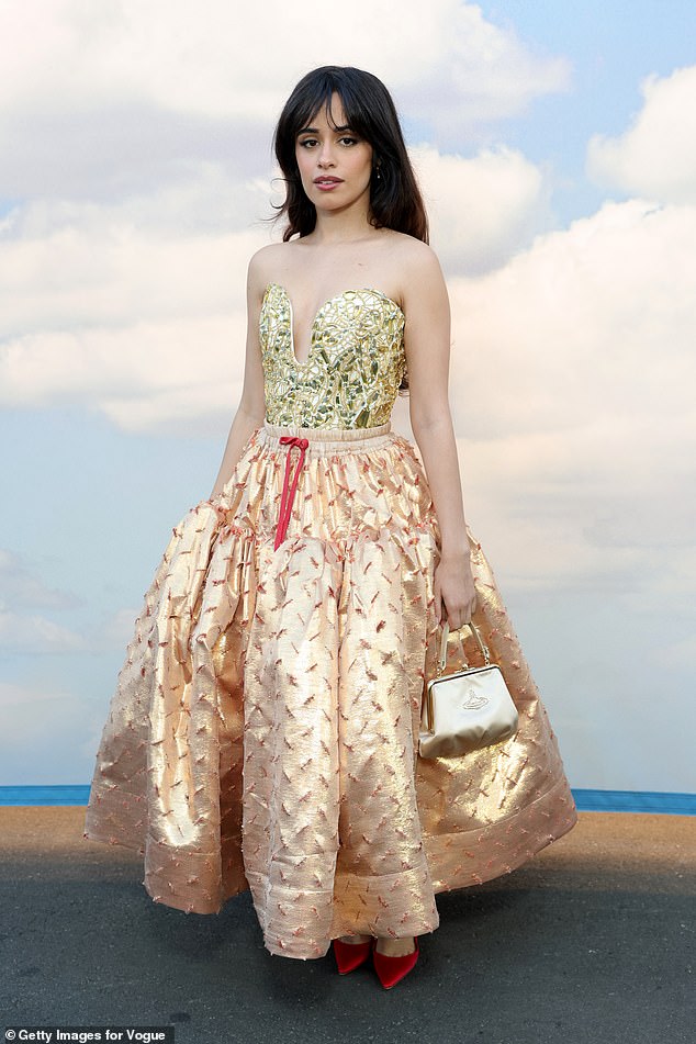 Camila Cabello, 28, made a dramatic entrance in a gold corset top with a shimmering metallic skirt for the show