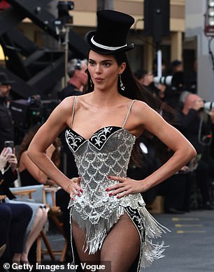 Kendall Jenner, 29, went full showgirl glam as she wore Nicole Kidman 's iconic Moulin Rouge costume as she strutted on the catwalk