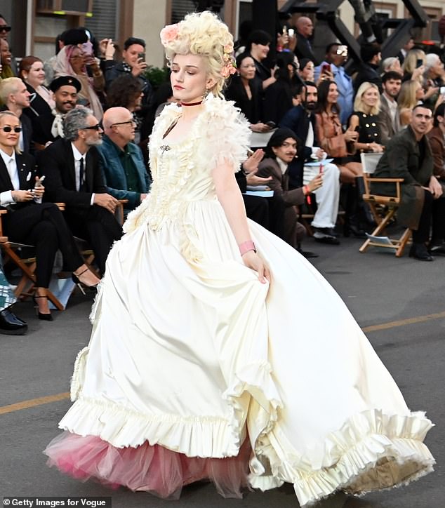 Julia Garner channeled Marie Antoinette has she donned a tall powdery wig and an ivory gown with ruffled details