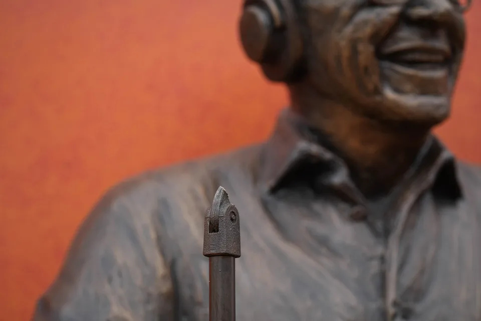 The microphone is mostly missing from Marty Brennanman's recently installed statue.