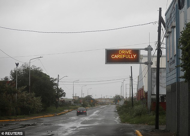 A car drives along a road, as Hurricane Melissa approaches, in Kingston, Jamaica, October 28, 2025. REUTERS/Octavio Jones
