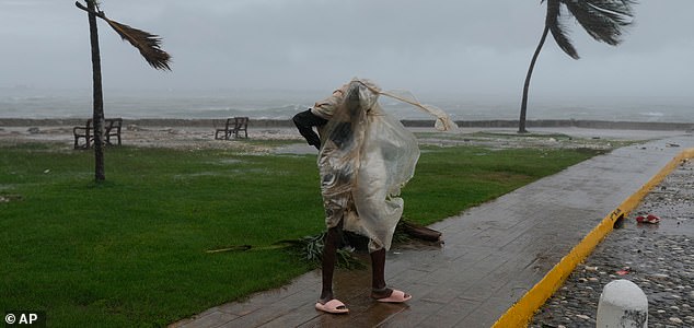 A man walks in Kingston, Jamaica, as Hurricane Melissa approaches, Tuesday, Oct. 28, 2025. (AP Photo/Matias Delacroix)