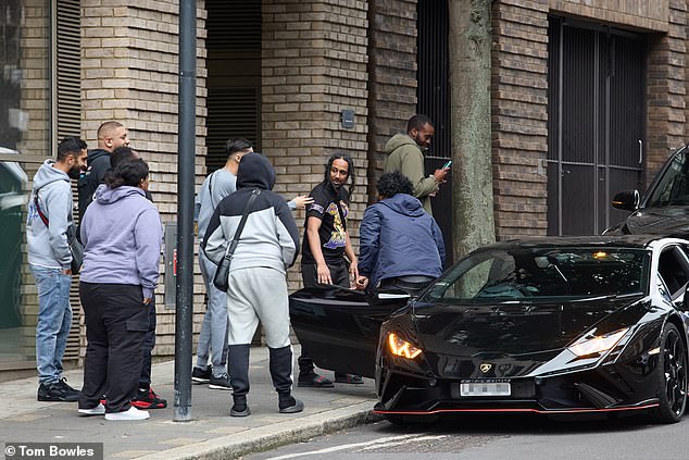 A former prisoner celebrates his early release with friends who picked him up in a Lamborghini