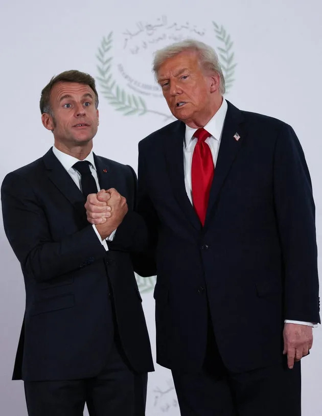 U.S. President Donald Trump and French President Emmanuel Macron pose for a photo at a world leaders' summit on ending the Gaza war in Sharm el-Sheikh, Egypt, on Oct. 13, 2025.